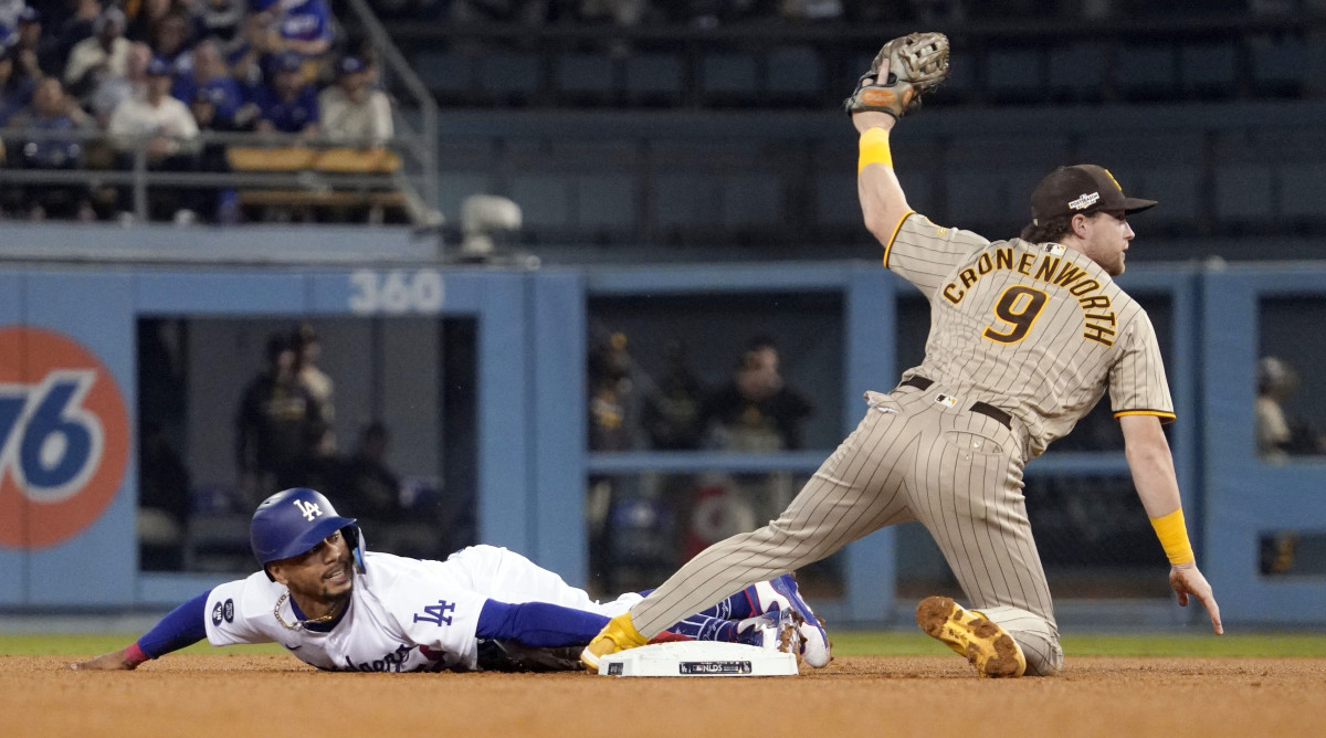Jake Cronenworth shows his glove after tagging Mookie Betts, who was attempting to steal second base.